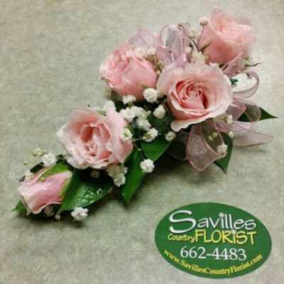 Pink rose corsage with baby's breath and ribbon