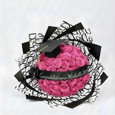 Pink rose bouquet with a graduation cap and black-and-white wrap