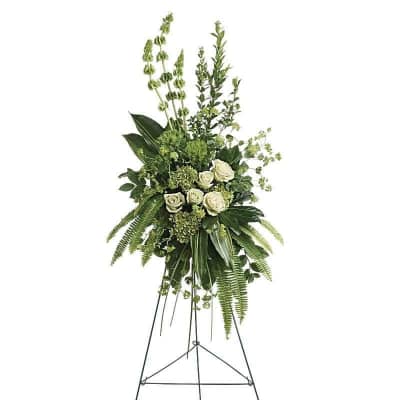 Tall white rose and greenery standing spray on an easel