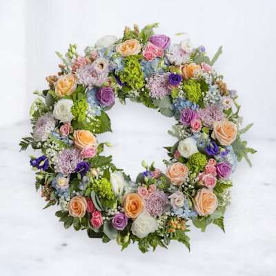 Circular floral wreath with pastel roses and mixed blooms