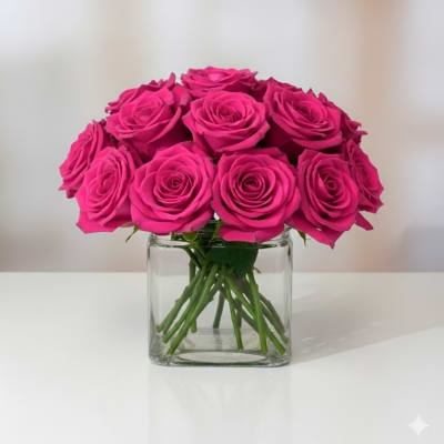 Pink roses arranged in a clear glass vase