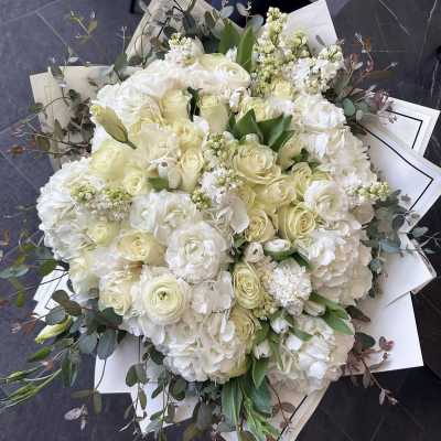 Large bouquet of white roses and hydrangeas with eucalyptus