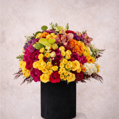 Bright mixed bouquet in a black cylindrical vase