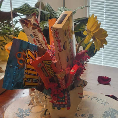 Candy bouquet with assorted chocolate bars and a yellow daisy