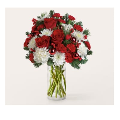 Red roses and white carnations in a clear glass vase