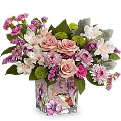 Pink and white flower arrangement in a square glass vase