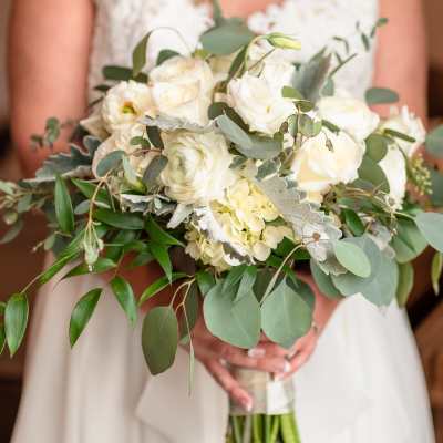 Bride holding a white bouquet with eucalyptus