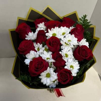 Bouquet of red roses and white daisies wrapped in black paper