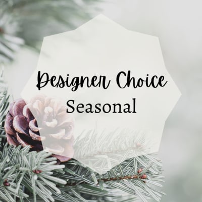 White tag reading Designer Choice Seasonal over pine branches and a pinecone