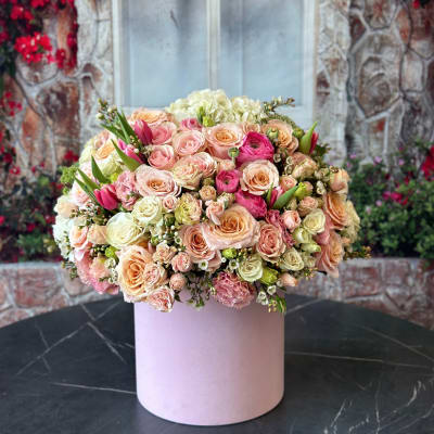 Large pastel bouquet of roses and tulips in a pink box