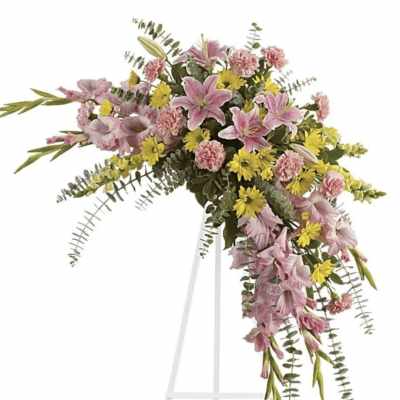 Pink and yellow floral spray on a white easel