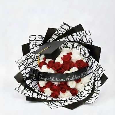 Bouquet of red and white roses with a graduation cap and ribbon