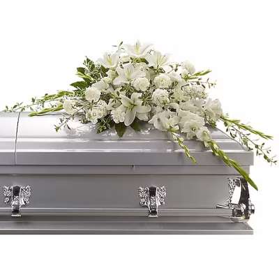 White floral spray on a silver casket