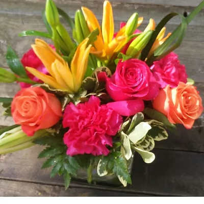 Bright bouquet of yellow lilies, pink roses, and orange roses