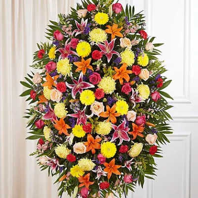 Large standing spray of mixed flowers in bright colors