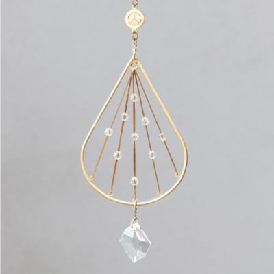 Gold teardrop hanging ornament with radiating strings, clear beads, and a faceted crystal drop