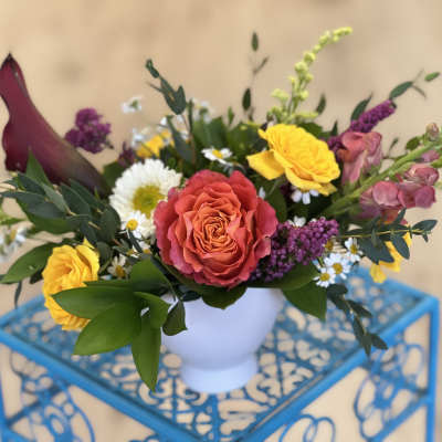 Colorful mixed bouquet in a white vase