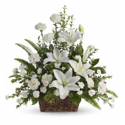 White lilies and carnations arranged in a wicker basket