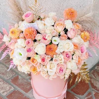 Large pastel bouquet of roses and dahlias in a pink hat box