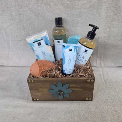 Wooden gift crate with sea salt bath products, lotions, sponge, and a blue bath bomb