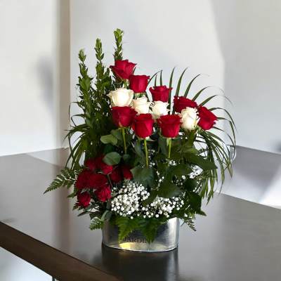 Red and white roses arranged in a silver vase