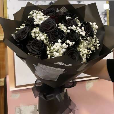 Bouquet of black roses with white baby's breath in black wrap
