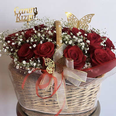 Basket of red roses with baby's breath and decorative ribbons