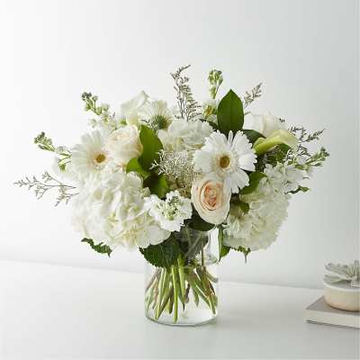 White floral arrangement in a clear glass vase