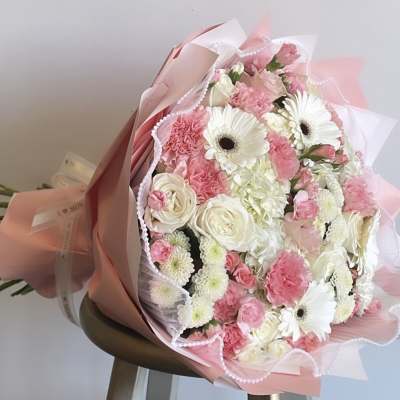 Pink and white mixed bouquet wrapped in pink paper