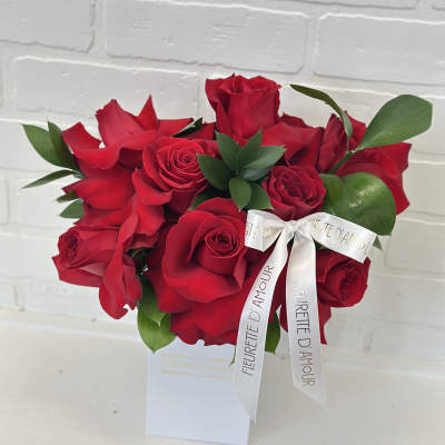 Red rose bouquet with a white ribbon in a white box