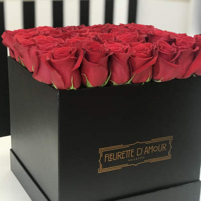 Red roses arranged in a black square box
