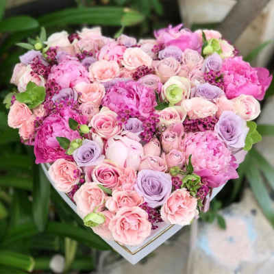 Heart-shaped bouquet of pink and lavender roses and peonies