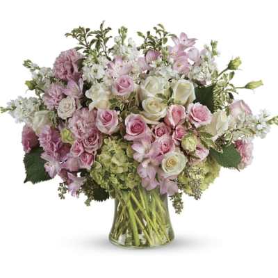 Pink and white mixed flower arrangement in a clear glass vase