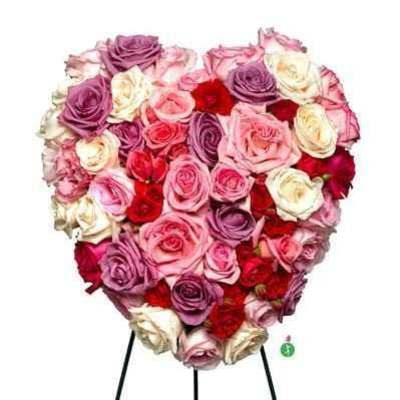 Heart-shaped bouquet of pink, purple, red, and white roses