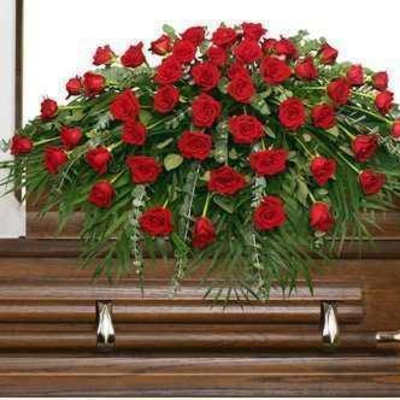 Red rose casket spray on a wooden casket