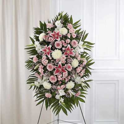 Standing floral spray with pink and white flowers on an easel