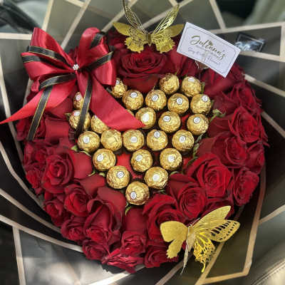 Red rose bouquet with gold-wrapped chocolates and butterfly decorations