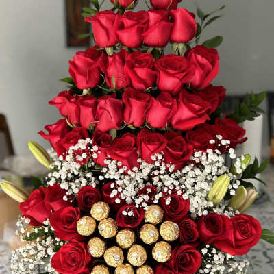 Tiered arrangement of red roses with baby’s breath and Ferrero Rocher chocolates