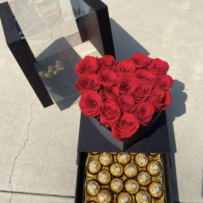 Heart-shaped red rose box with chocolates in a black gift case