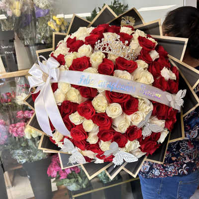 Large bouquet of red and white roses with a tiara and ribbon