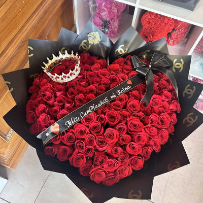 Large bouquet of red roses with a crown and black ribbon