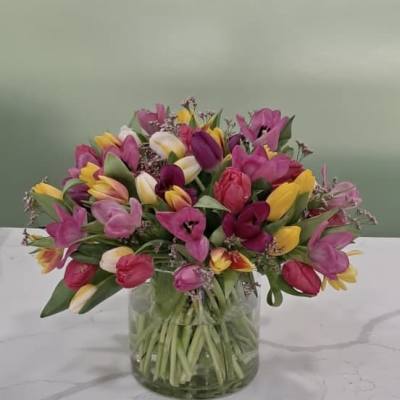 Mixed tulip bouquet in a clear glass vase