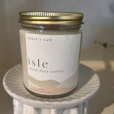 Soy wax candle in a glass jar with a gold lid