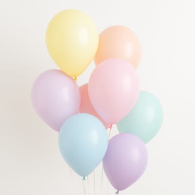 Cluster of pastel balloons in yellow, pink, blue, and lavender