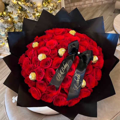 Red rose bouquet with gold-wrapped chocolates and black ribbon
