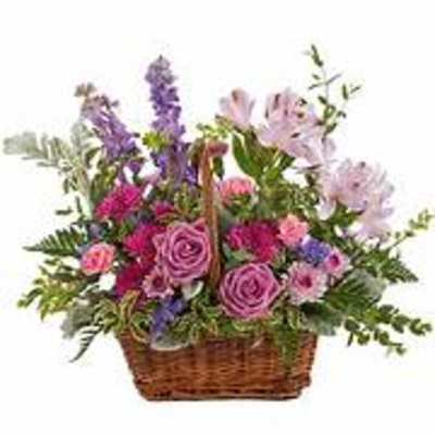 Basket arrangement of pink and purple flowers with greenery