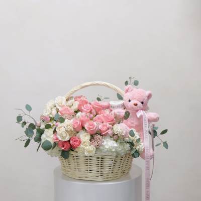 Pink and white rose basket with a pink teddy bear
