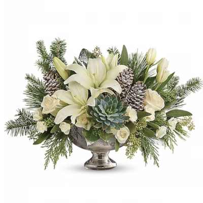 White lilies and roses in a silver pedestal bowl with pinecones and greenery