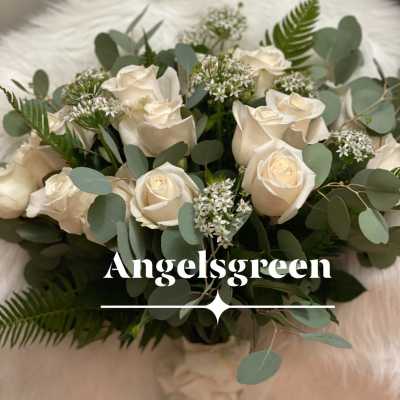 Cream roses arranged with eucalyptus and small white filler flowers