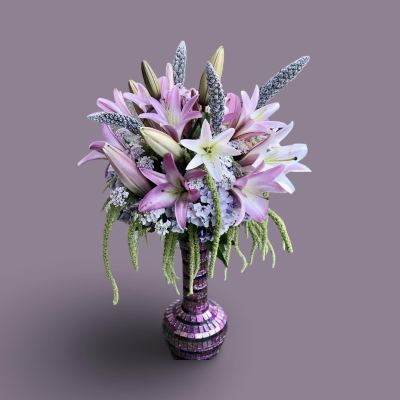 Bouquet of pink and white lilies in a mosaic vase